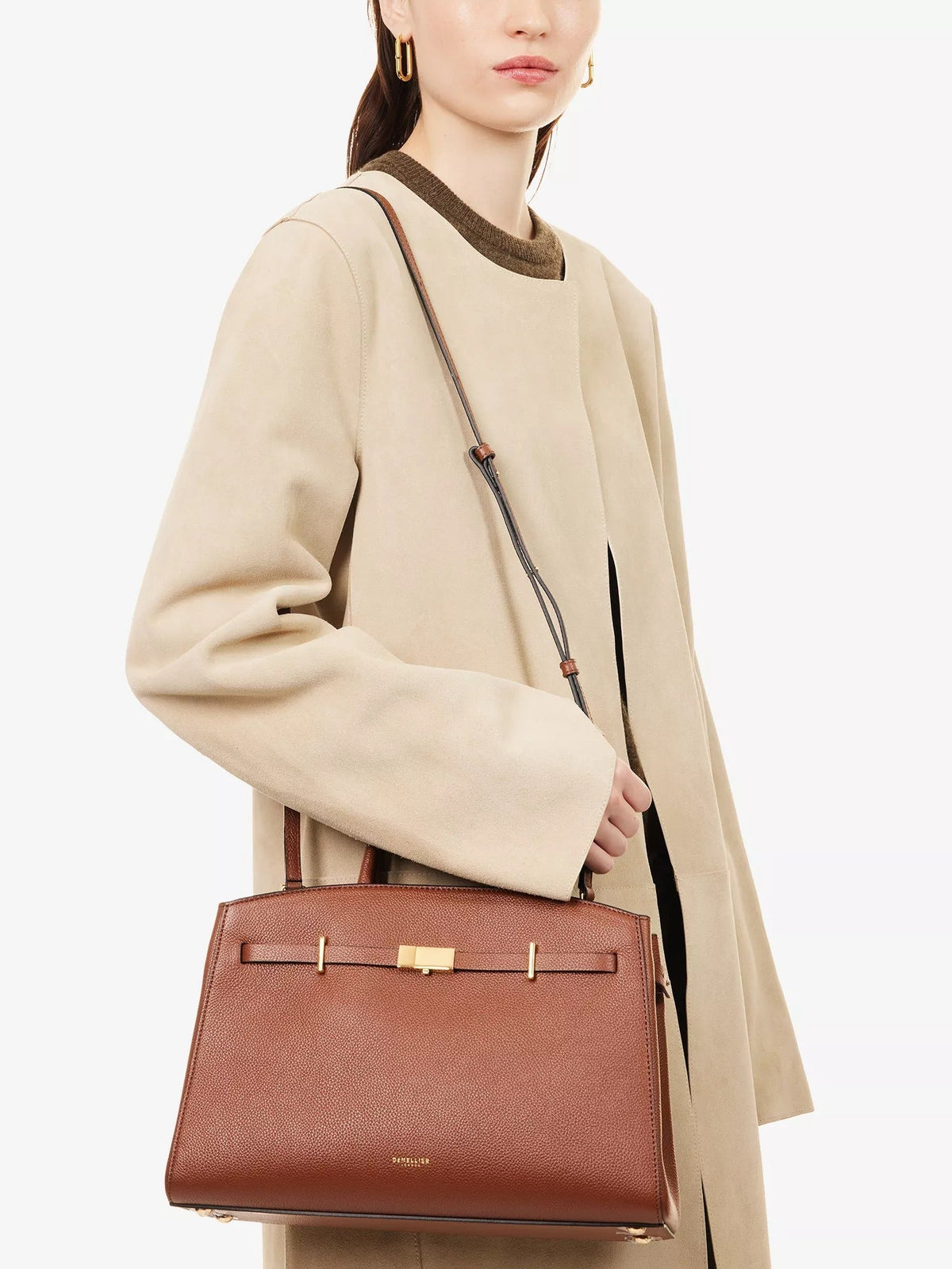 Amélisse midi handbag in brown worn on the shoulder strap
