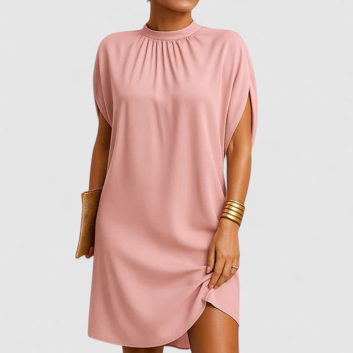 Larissa elegant dress in pink, front view with clutch