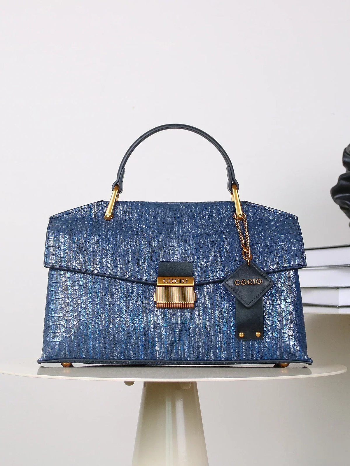 Selene python tote bag in royal blue, front view with leather charm