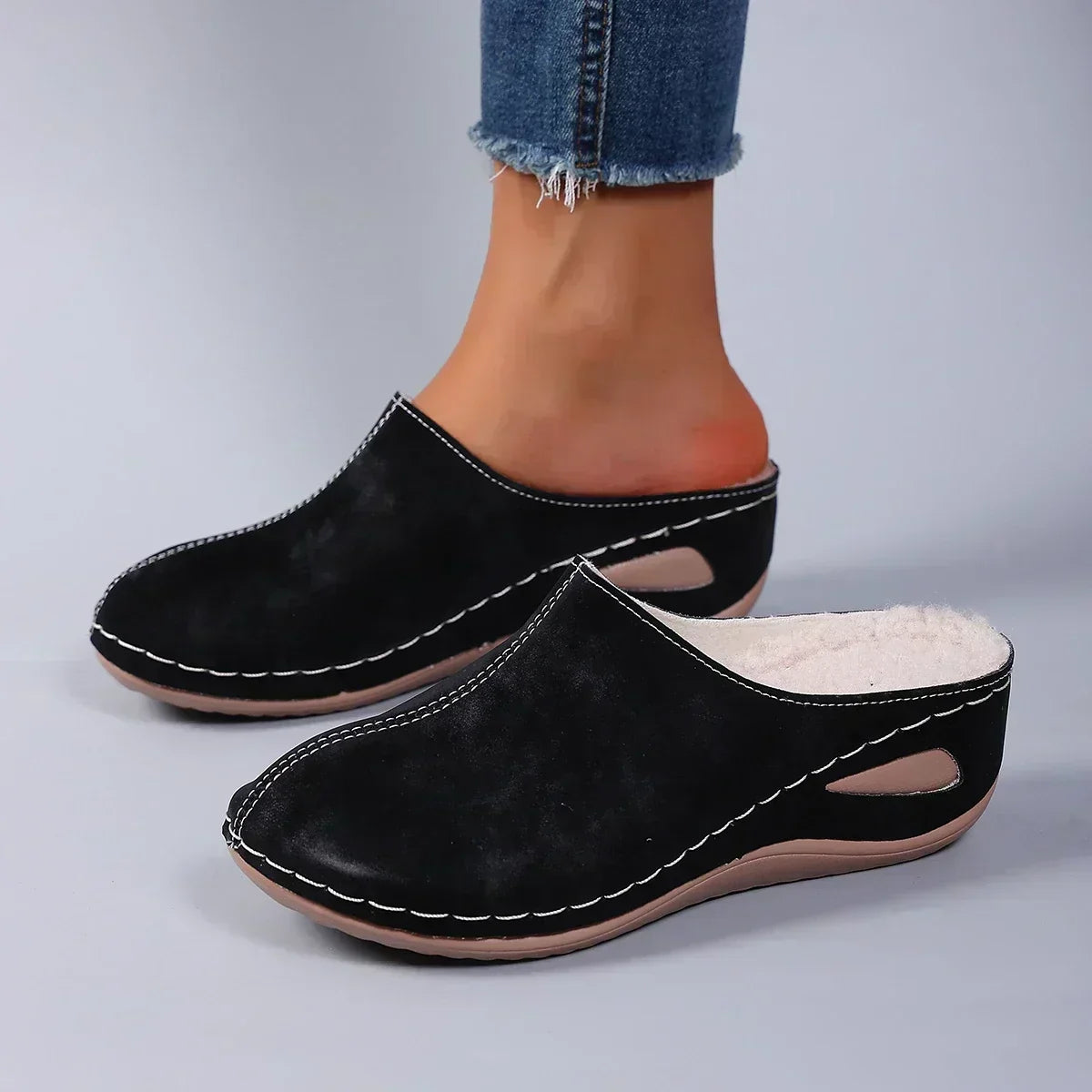 Sophie orthopaedic slippers in black, worn side view with jeans