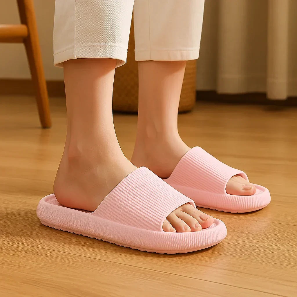 Platform slide slippers in pink, worn indoors, three-quarter view