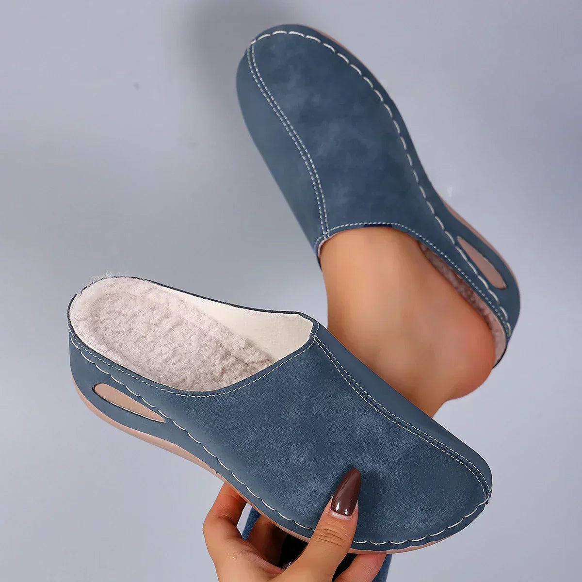Sophie orthopaedic slippers in blue, pair held to show soft footbed