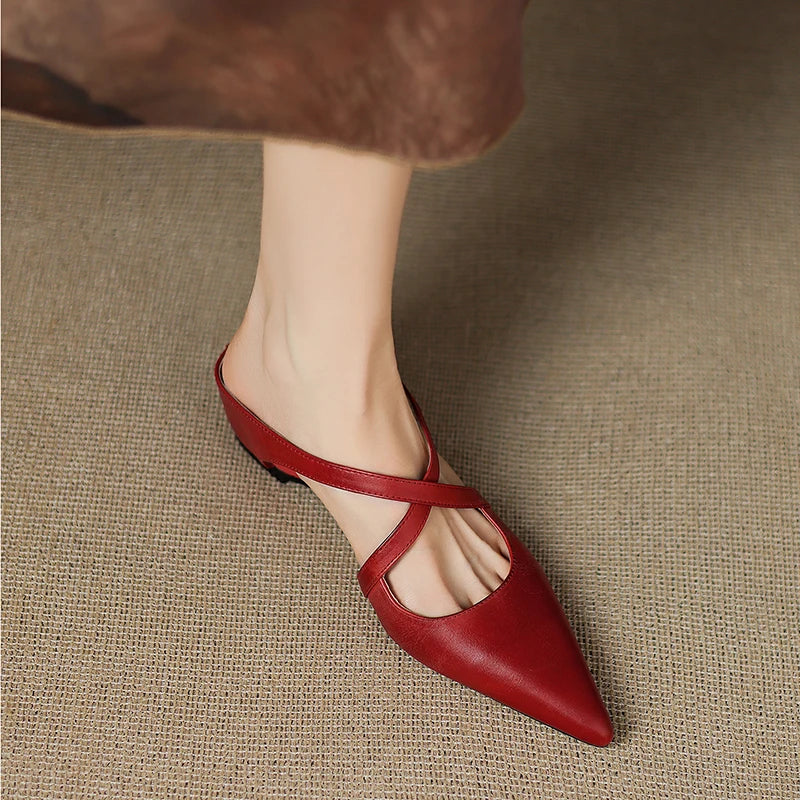 Aluna leather mules in maroon, angled front view worn with skirt