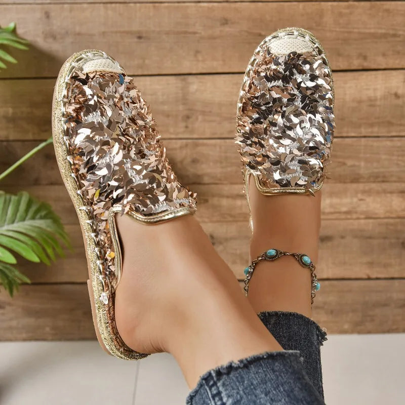 Sequinned slip-on flats in gold, worn angled view