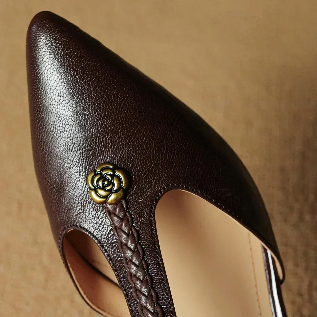 Kathy sandals in brown, close-up of metallic rose accent and braided strap