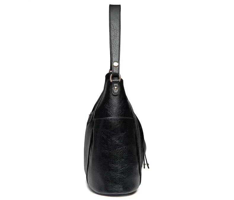 Calista luxe shoulder bag in black, side profile view