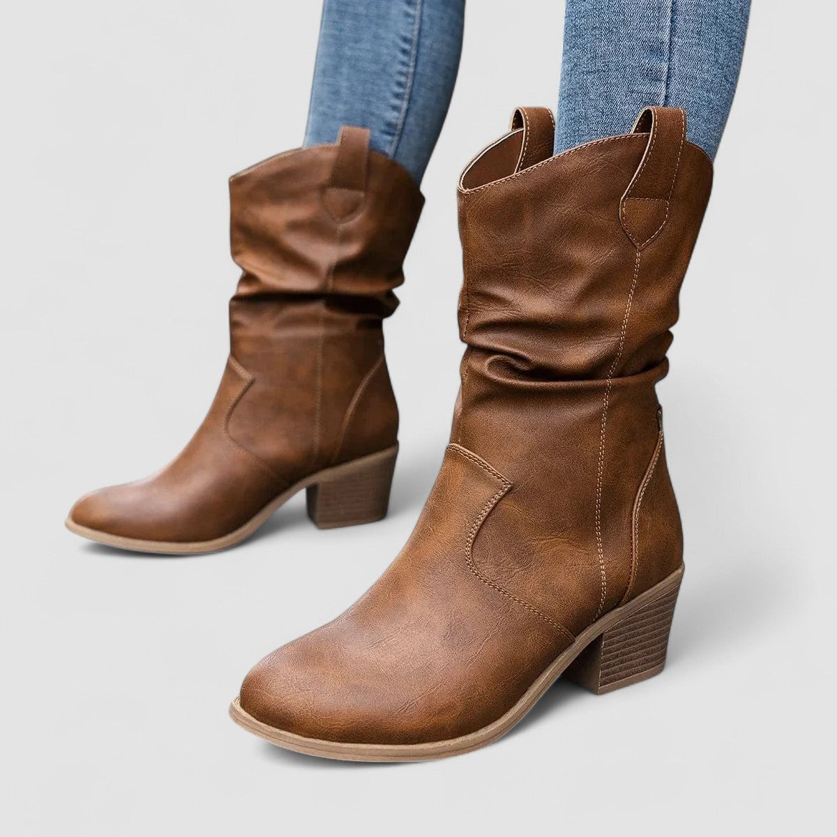 Eleanora slouch heeled boots in brown, standing side view