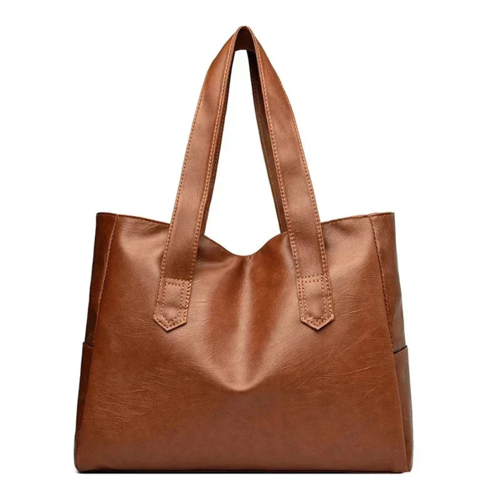 Susan shoulder bag in brown, straight-on front view with flat handles