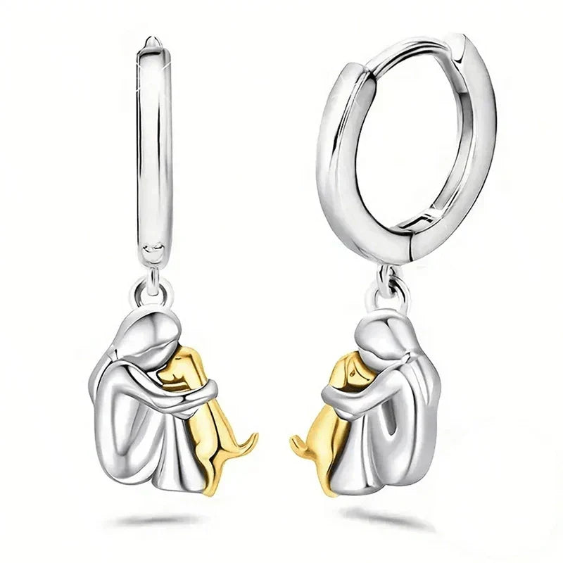 Seleno dog icon earrings in gold and silver, pair shown upright