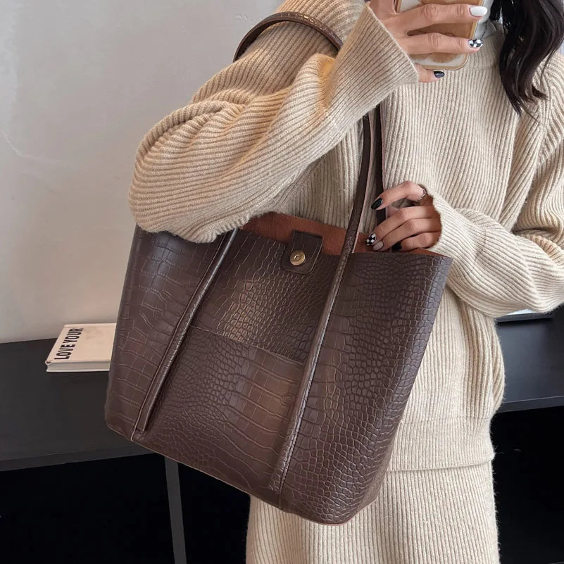 Sylvette croc shoulder bag in coffee, close-up of stud tab and front pocket