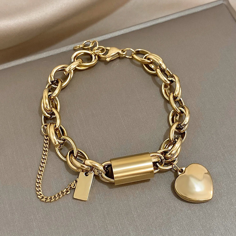 Chunky gold heart bracelet with oversized links and heart charm