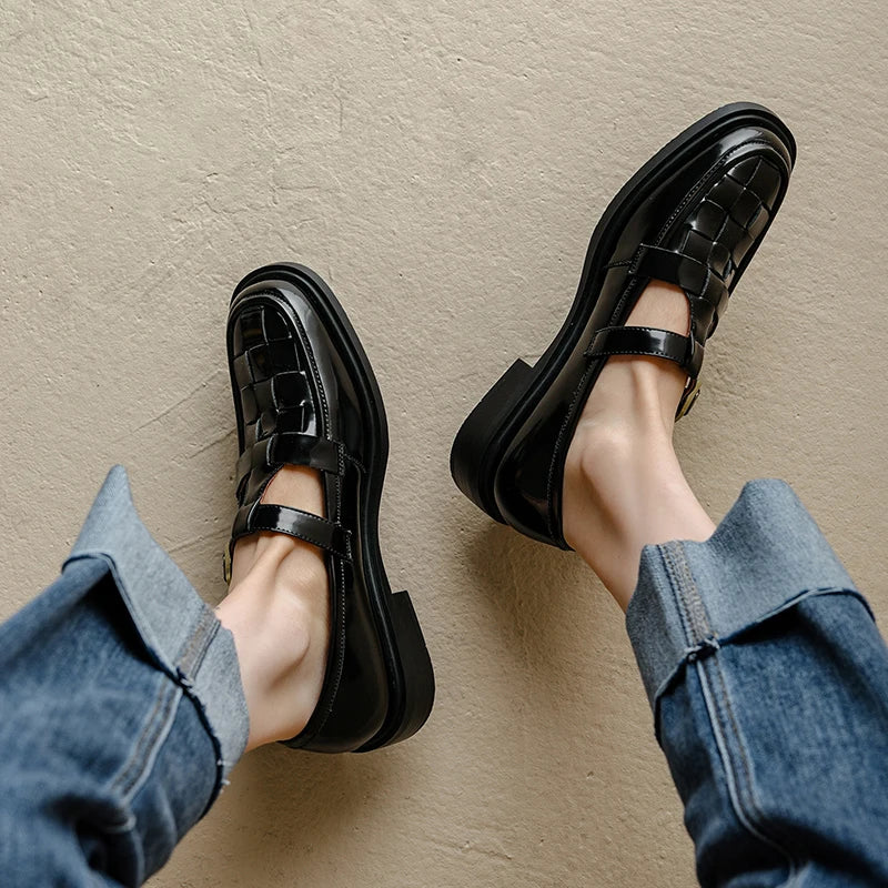 Isava flats in black, overhead view showing woven leather toe