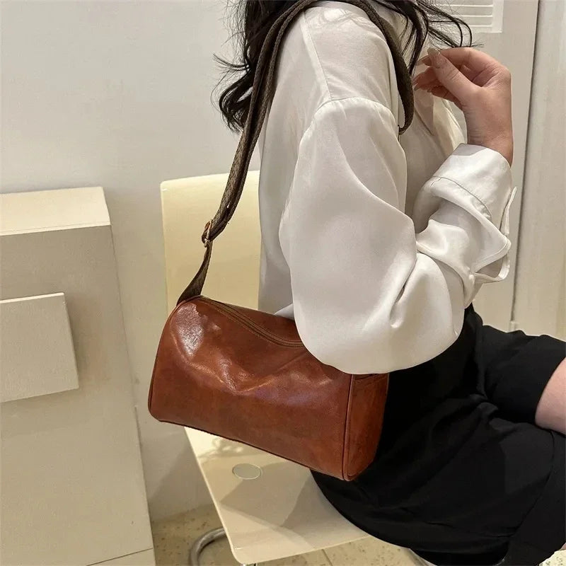Florence crossbody bag in brown, worn over a white shirt