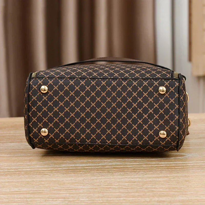 Marjorie charm bag in coffee, base view with metal studs