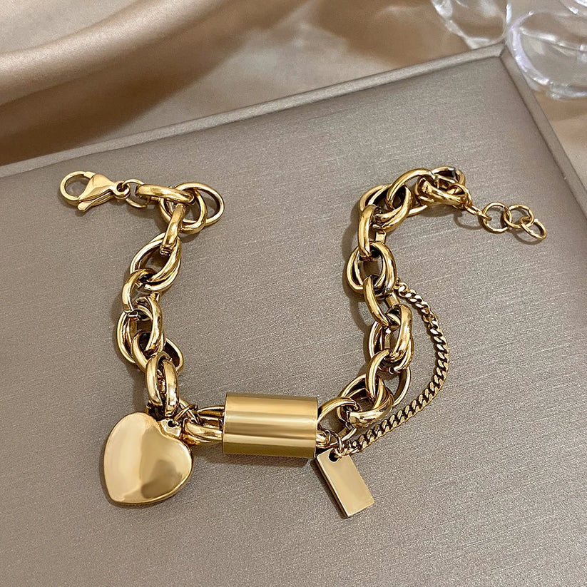 Gold chunky link bracelet shown from above with tag charm