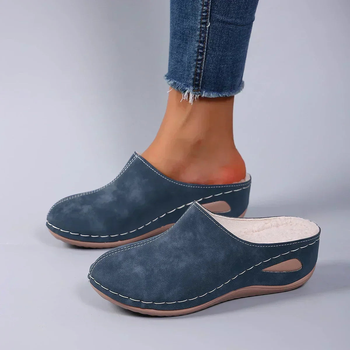 Sophie orthopaedic slippers in blue, worn side view with jeans