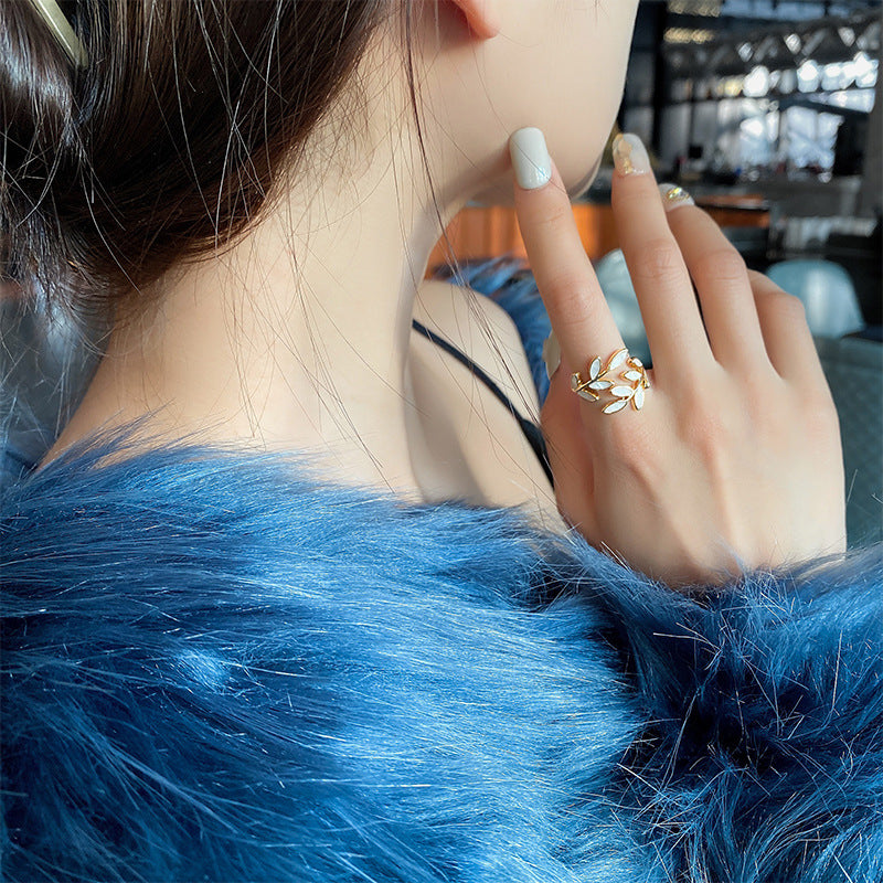 Leaf and opal adjustable ring worn on a model's finger