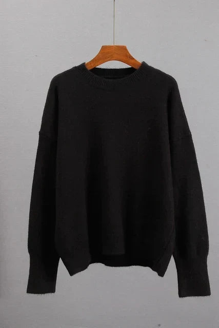 Alice cashmere sweater in black, shown on a hanger