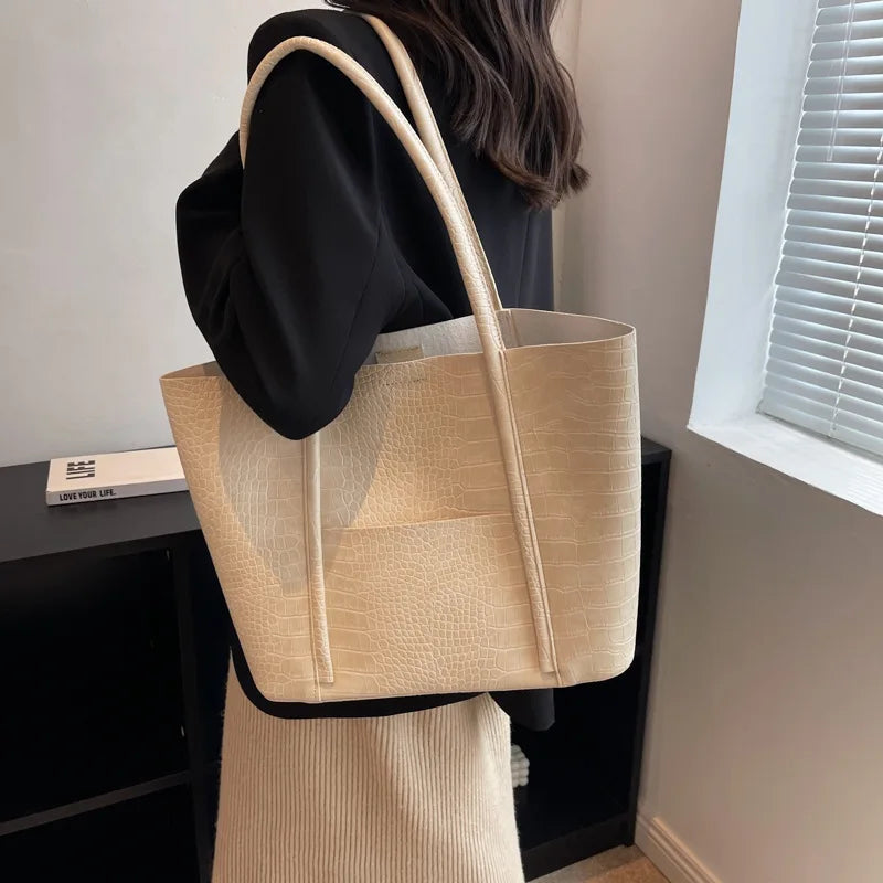 Sylvette croc shoulder bag in beige, worn on the shoulder