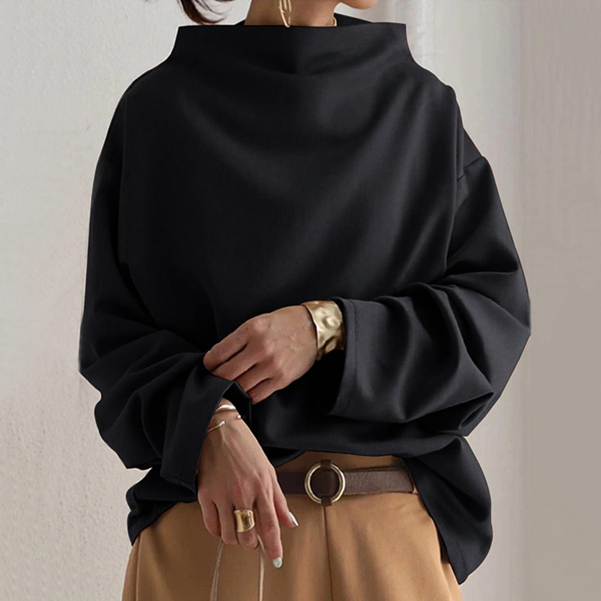 Elspeth high-neck casual top in black, front view with camel trousers