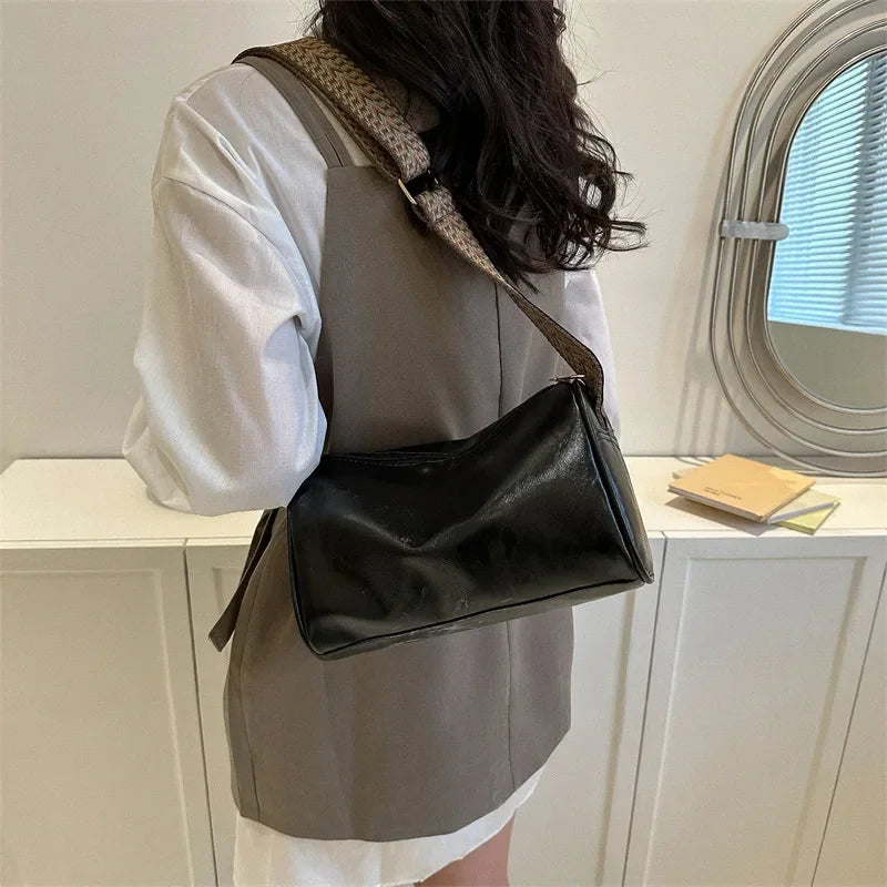 Florence crossbody bag in black, worn across the body