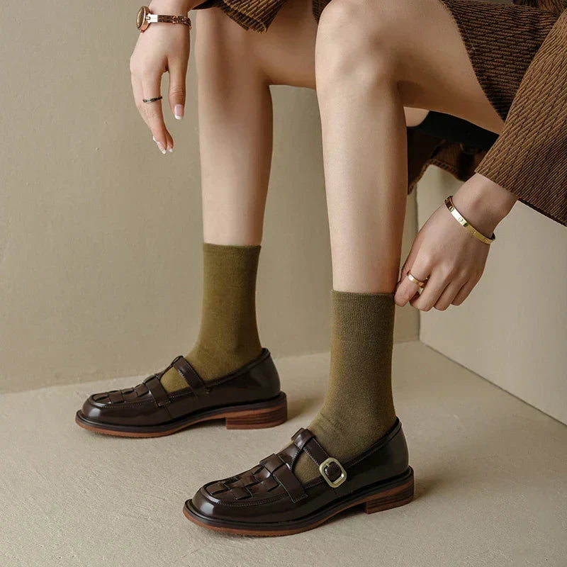 Isava vintage-style flats in brown, side view worn seated
