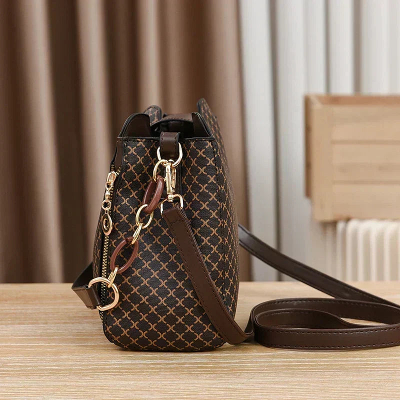 Marjorie charm bag in coffee, side view showing gold chain trim