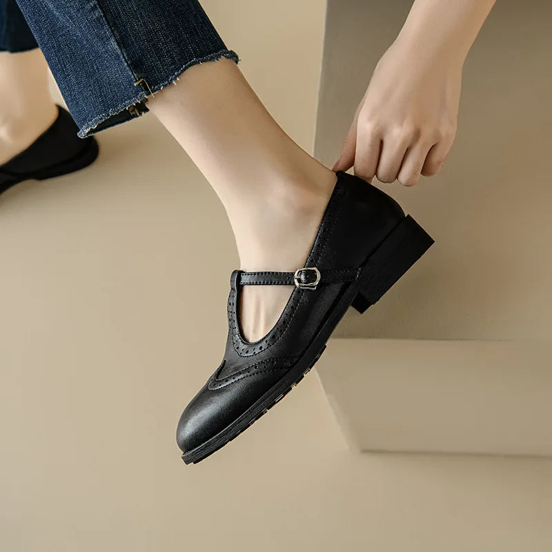 Miana T-strap Mary Janes in black, close-up of buckle and low heel