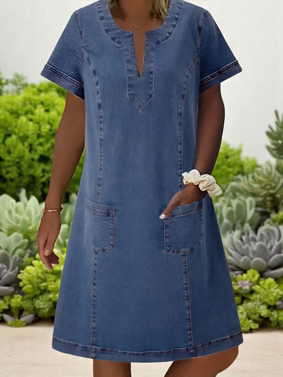 Sky denim dress in mid blue, front view with patch pockets