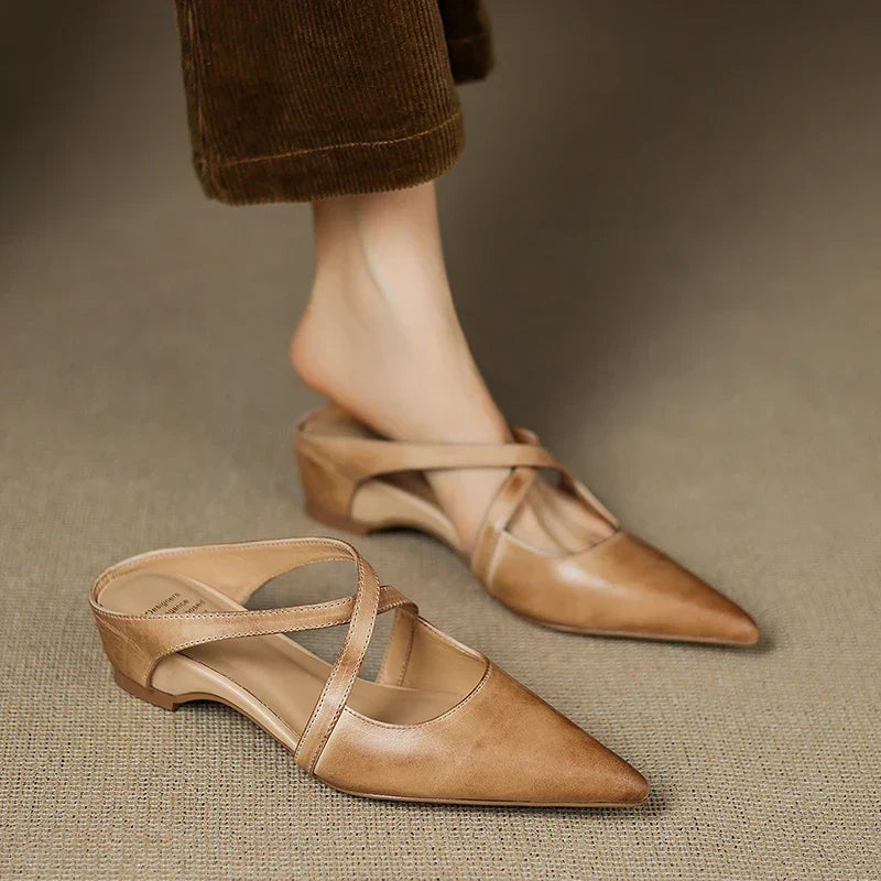 Aluna pointed-toe leather mules in apricot, worn with corduroy trousers