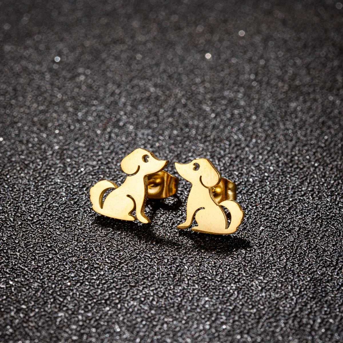 Gold dog stud earrings with smiling silhouette detail