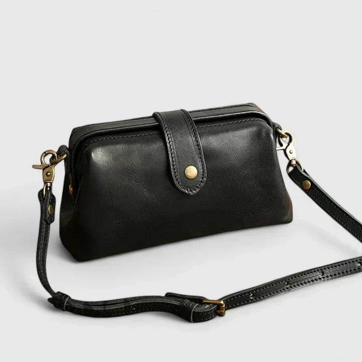 Isola structured leather shoulder bag in black, side front view