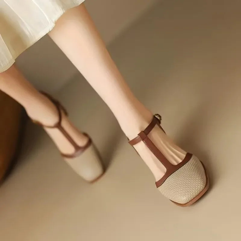 Genira mid-heel classic shoes in beige worn with a white skirt, front view