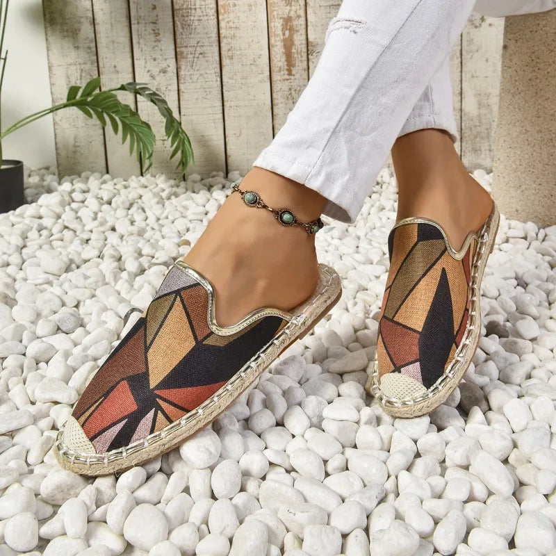 Slip-on flats in terracotta geometric print, worn side view