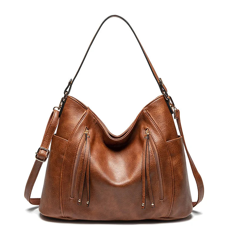 Calista luxe shoulder bag in brown, front view with tassel zips