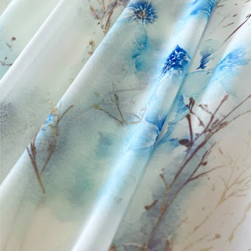 Close-up of Morwenna dress fabric with blue floral watercolour print