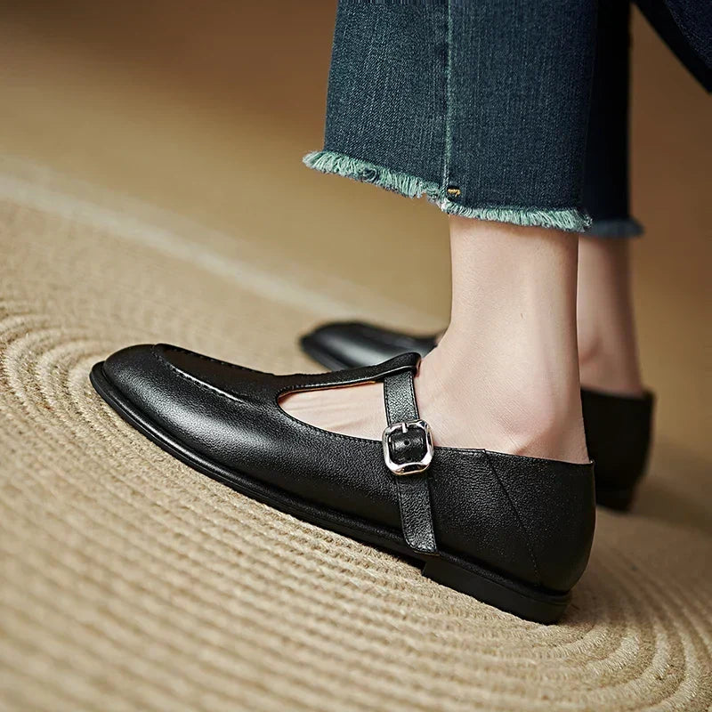 Laura black pumps side view showing low heel and buckle