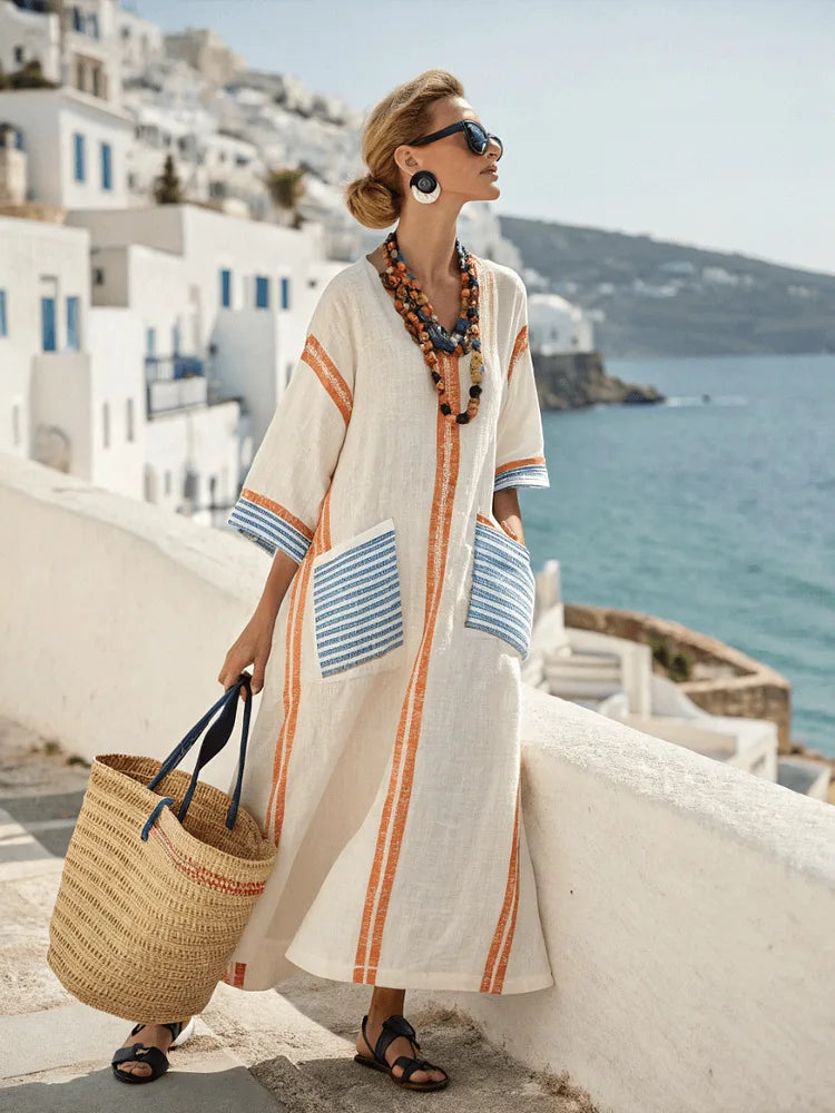 Vera striped kaftan dress in orange and blue, showing patch pockets