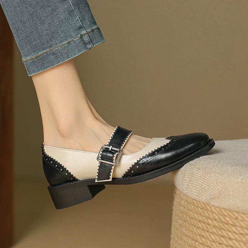 Lumerra Mary Janes in black and cream, side view of buckle strap