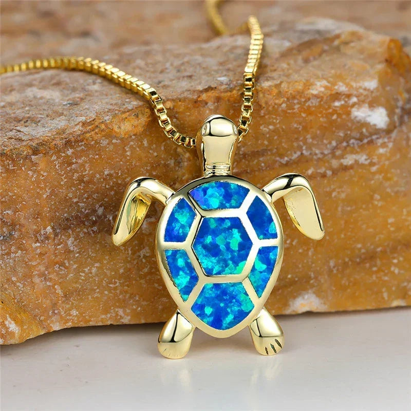 Opal turtle pendant necklace in gold tone with blue shell panels