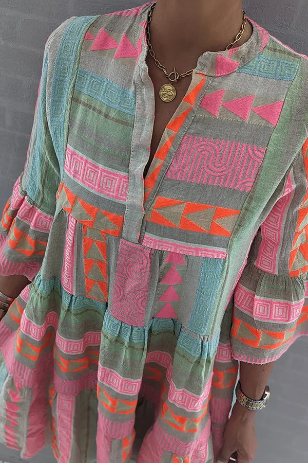 Detail of Chloe dress ruffled tiers and neon geometric pattern