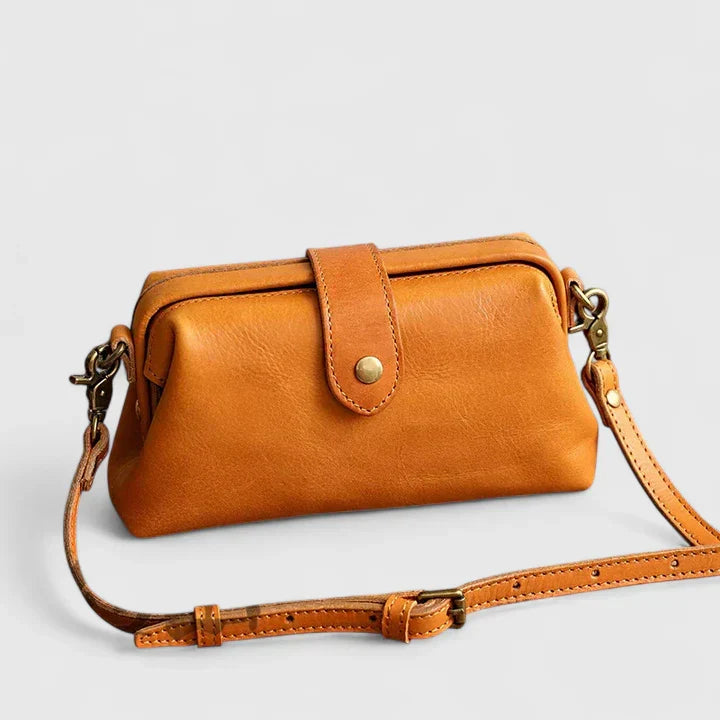 Isola structured leather shoulder bag in orange, three-quarter front view