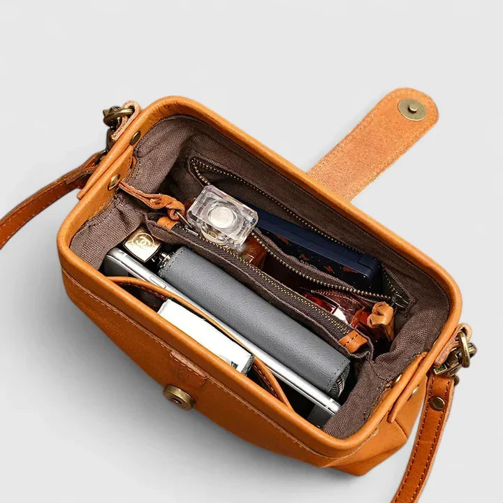 Isola bag interior in orange with zipped compartment holding phone and purse