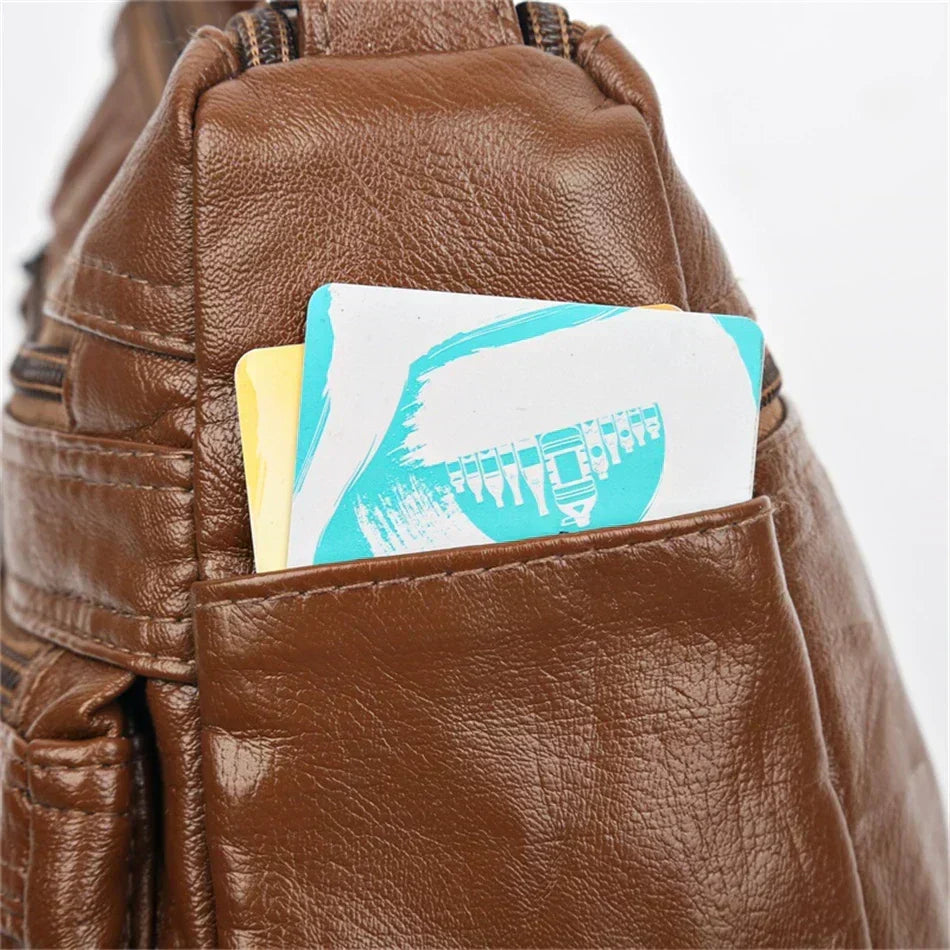 Close-up of Olivia bag side slip pocket holding cards