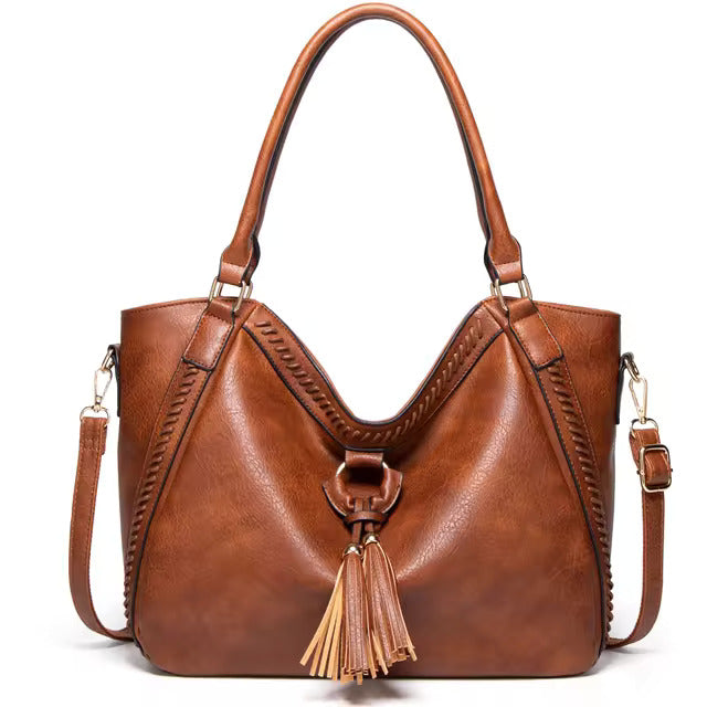 Elowen premium leather tote bag in brown, front view with tassel detail