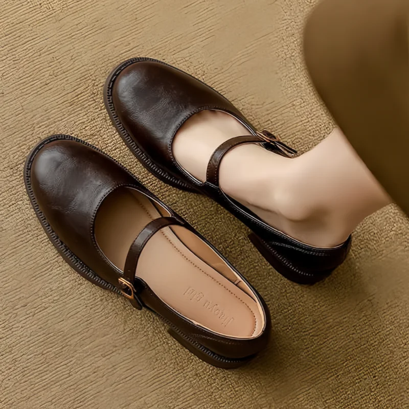 Dorvanna Mary Janes in brown, worn top view with buckled strap