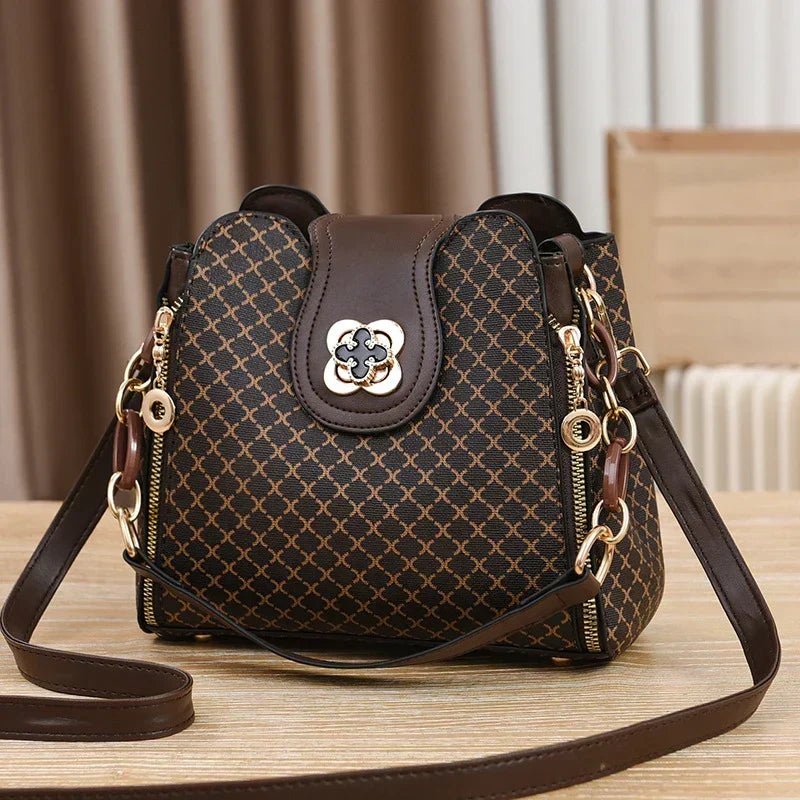 Marjorie charm bag in coffee, front view with floral twist-lock clasp
