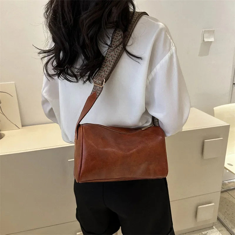 Florence crossbody bag in brown, back view worn crossbody