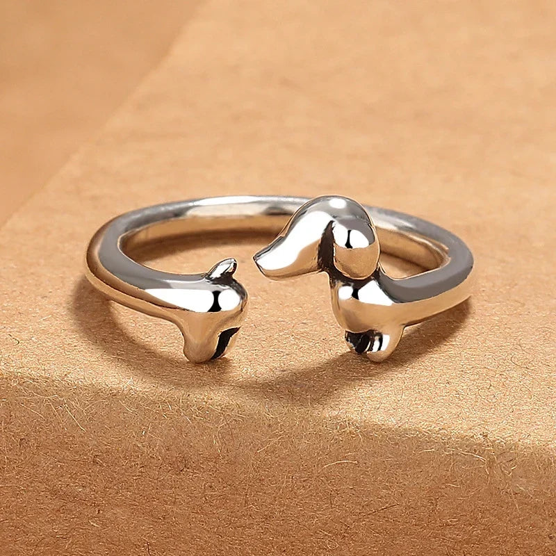 Adjustable dog ring in silver tone, angled view on card