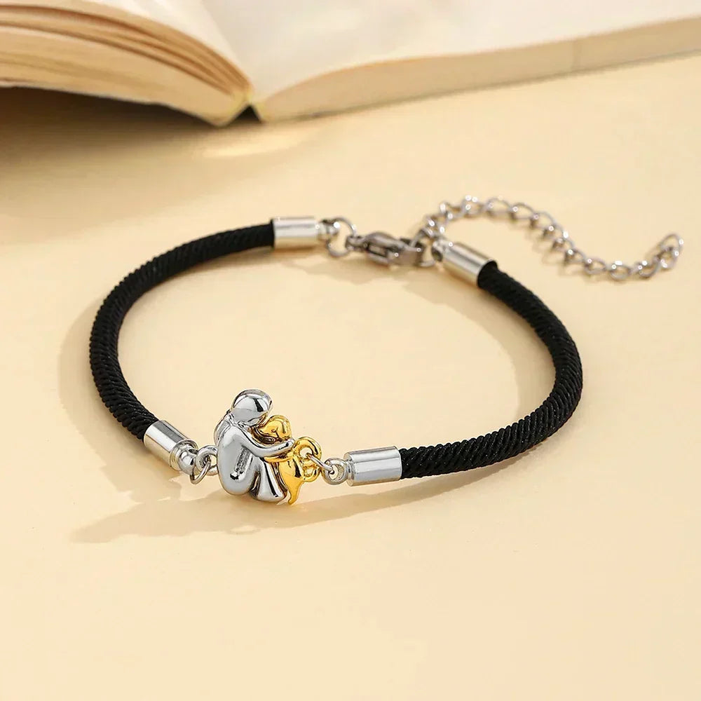 Black cord dog bracelet with clasp and extender chain, styled flat